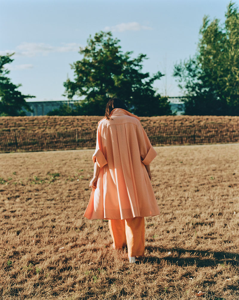 Artist coat in Italian wool or cotton canvas with stand collar and back box pleat detail